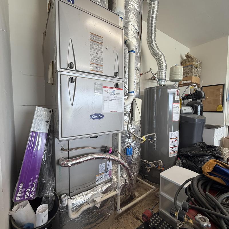 HVAC air handler with ductwork and water heater nearby HVAC air handler with ductwork and water heater nearby