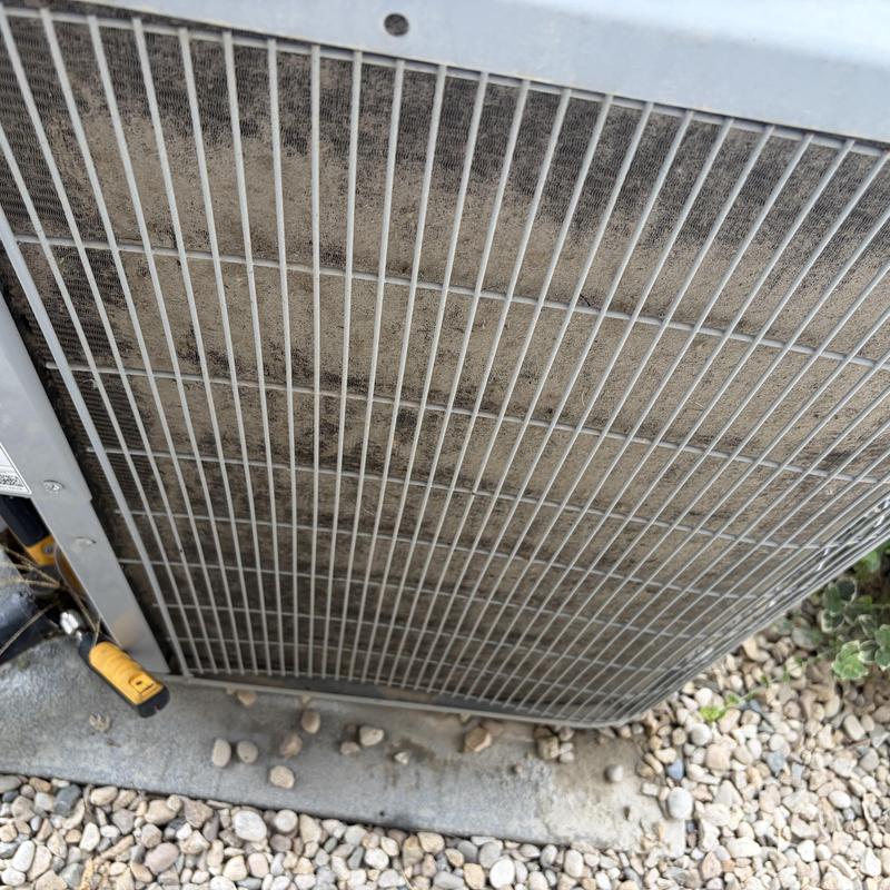 HVAC condenser coil with dirt buildup on protective grille HVAC condenser coil with dirt buildup on protective grille