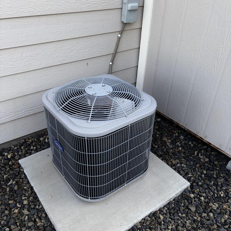 Outdoor air conditioner condenser unit on concrete pad Outdoor air conditioner condenser unit on concrete pad