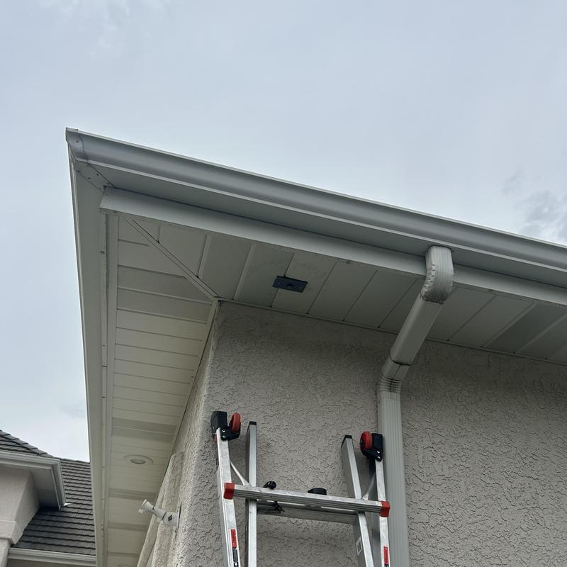 Exterior photocell replacement under roof eaves with ladder Exterior photocell replacement under roof eaves with ladder