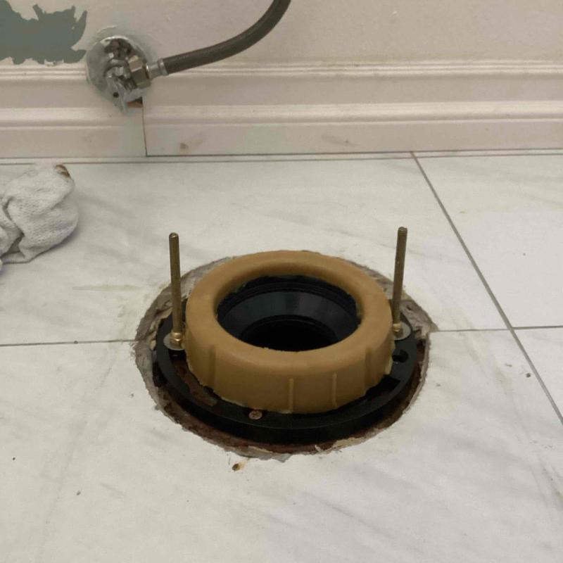 Toilet flange installation on tiled floor