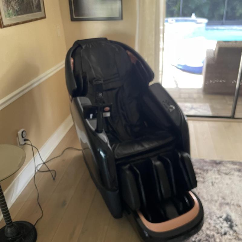 Massage chair in living room near glass door