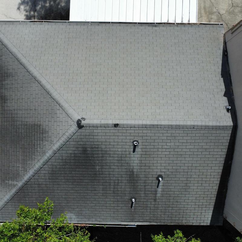 Shingle roof with vent pipes and discoloration Shingle roof with vent pipes and discoloration