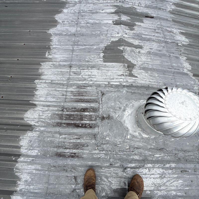 Metal roof panels with hail damage and vent turbine