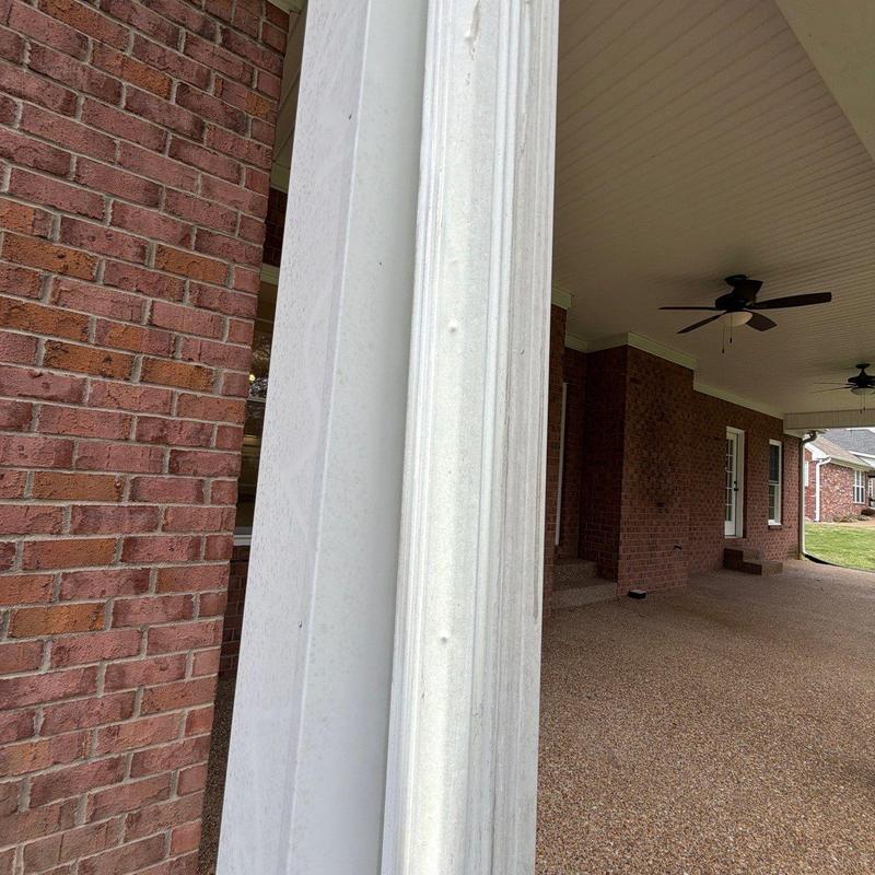 Vinyl porch column with hail damage dents