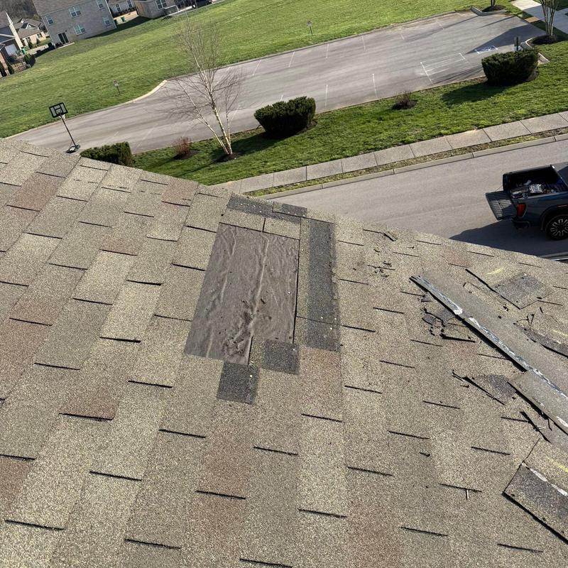Roof shingle damage and patch on residential roof
