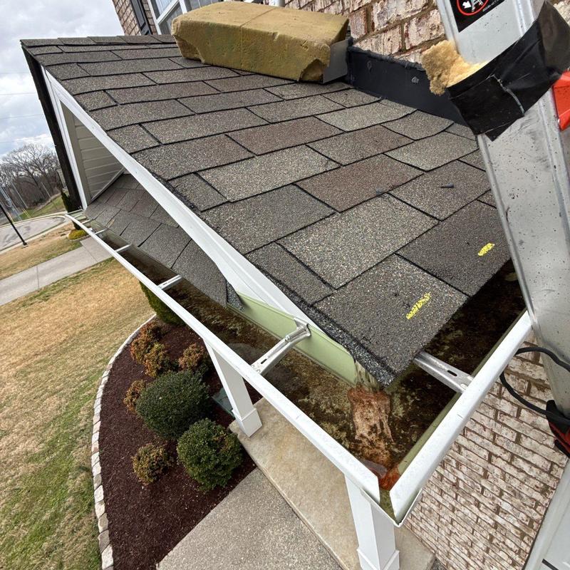 Asphalt shingle roof and gutter with hail damage marked