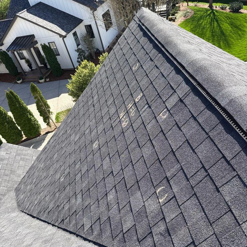 Asphalt shingles with hail damage markings on roof
