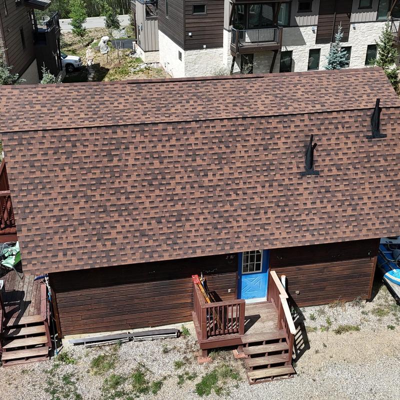 Asphalt shingle roof with pipe vent flashing and ridge vents