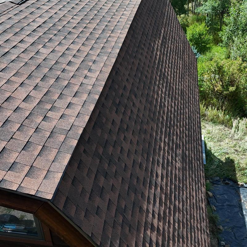 Asphalt shingle roof with ridge ventilation after replacement