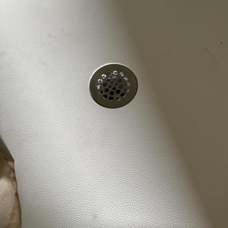 Shower drain with new PVC p-trap installed in tub base Shower drain with new PVC p-trap installed in tub base