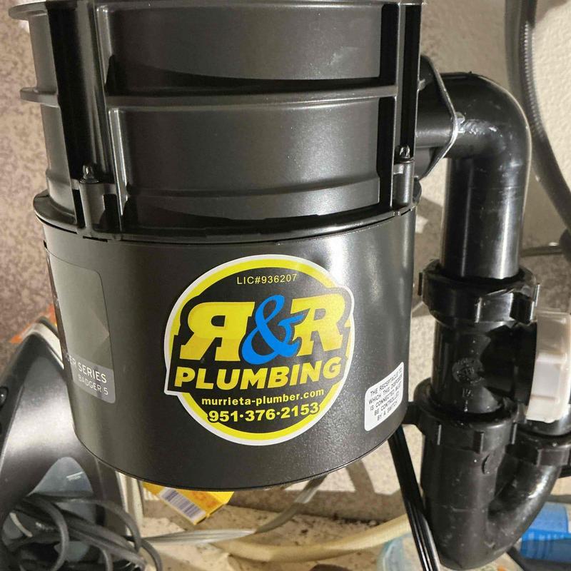 Badger 5 garbage disposal with plumbing pipes