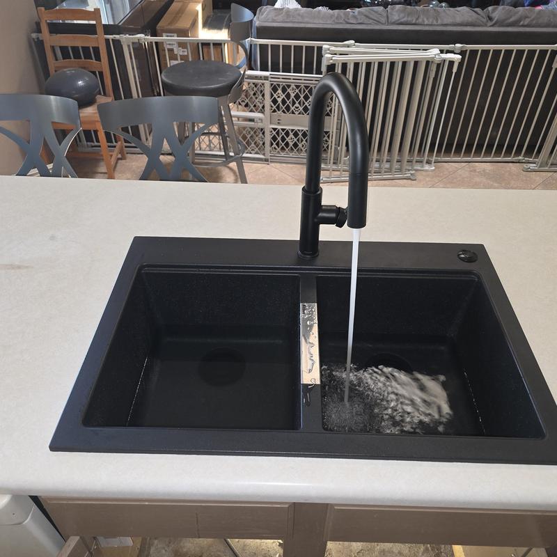 Kitchen sink with black faucet running water Kitchen sink with black faucet running water