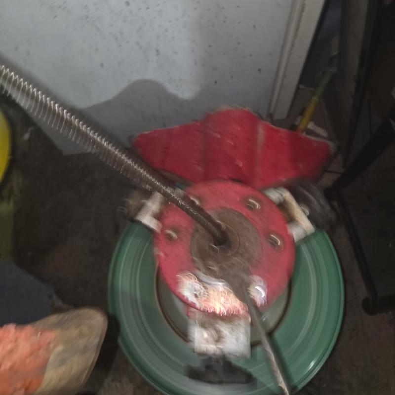 Sewer drain cleaning machine with cable auger
