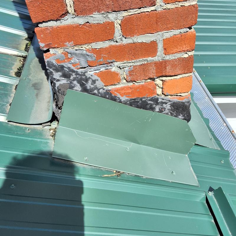Chimney metal flashing with damaged sealant and panels