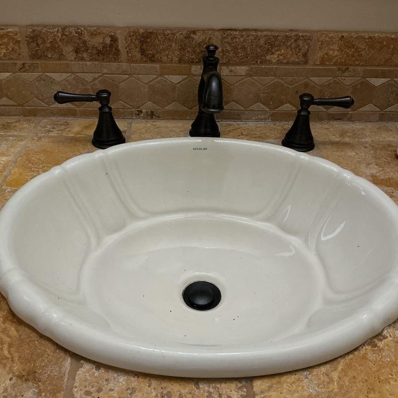 Bathroom faucet and sink installation with black fixtures