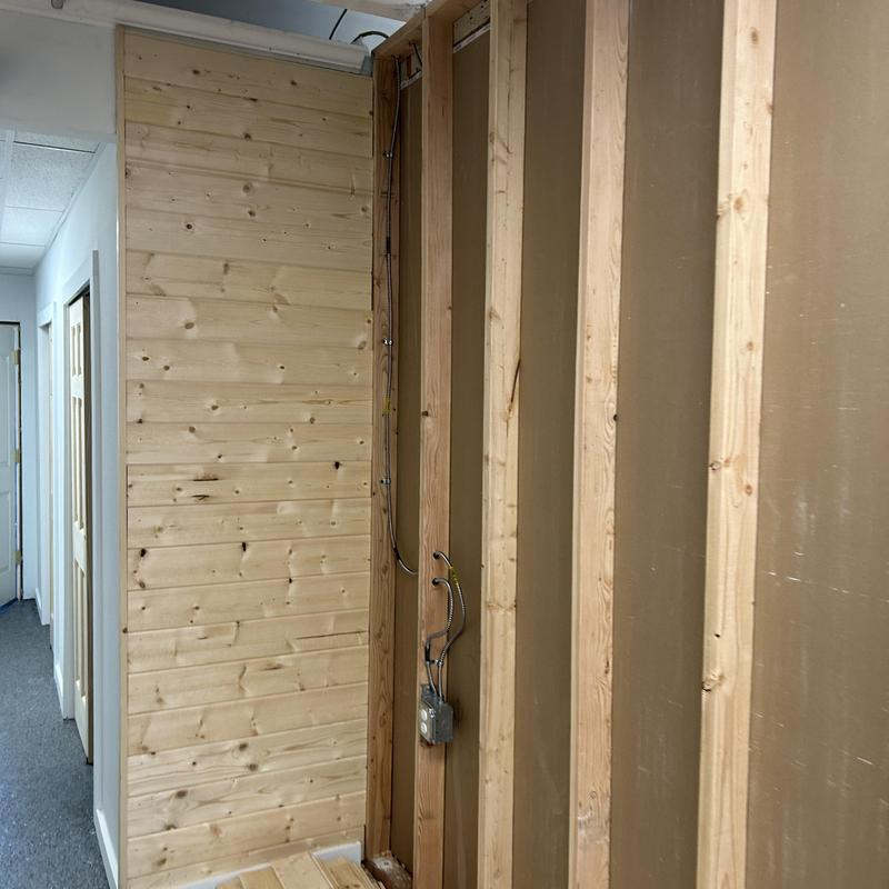 Electrical wiring installation in wall framing with wood paneling Electrical wiring installation in wall framing with wood paneling