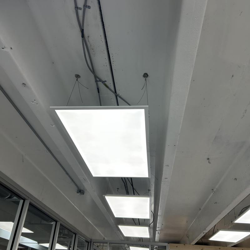 Drop-in LED light fixtures hung from ceiling in room Drop-in LED light fixtures hung from ceiling in room
