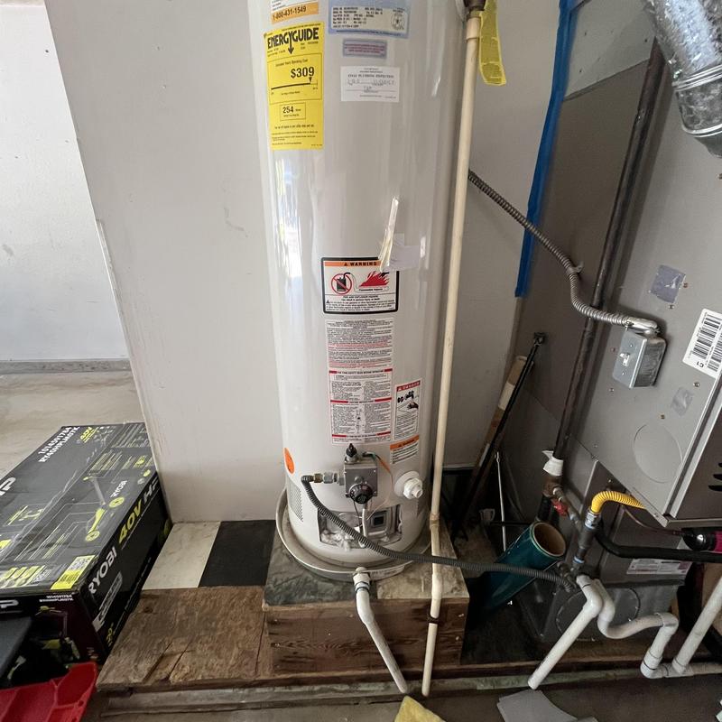 Water heater installation with connected plumbing lines Water heater installation with connected plumbing lines
