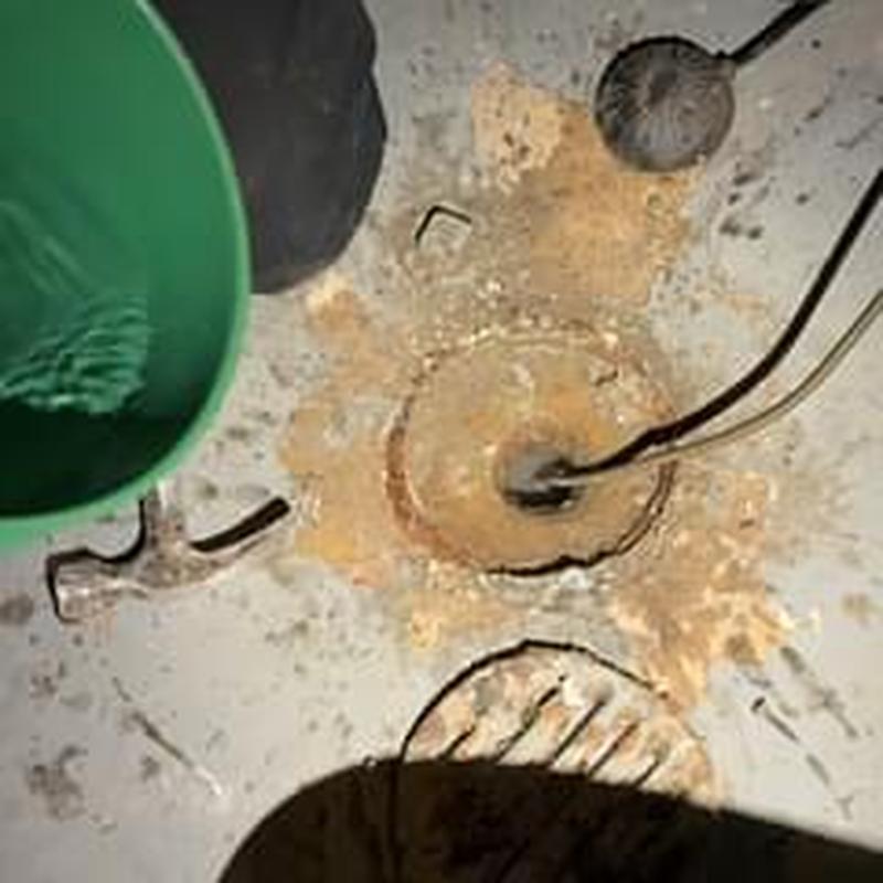 Floor drain clearing in basement with plumbing tools Floor drain clearing in basement with plumbing tools