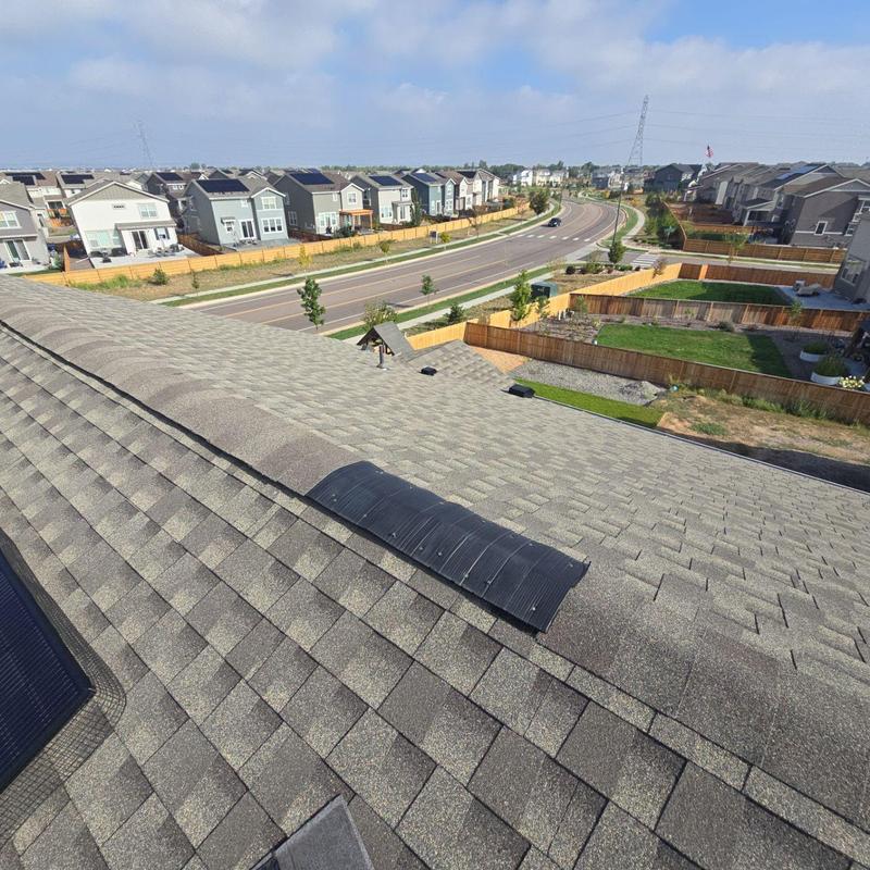 Roof ridge with resealed shingles and vents Roof ridge with resealed shingles and vents