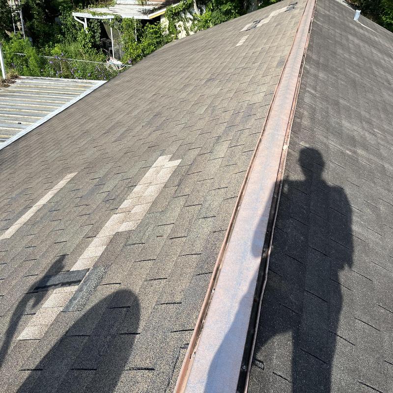 Asphalt shingle roof with ridge cap and repairs