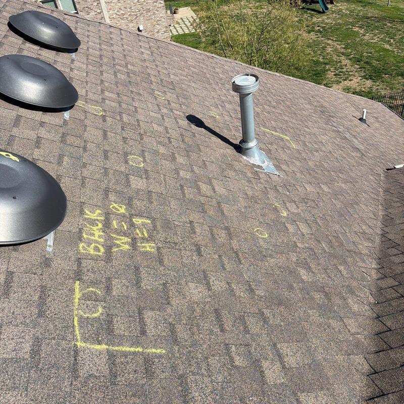 Asphalt shingle roof with hail damage markings