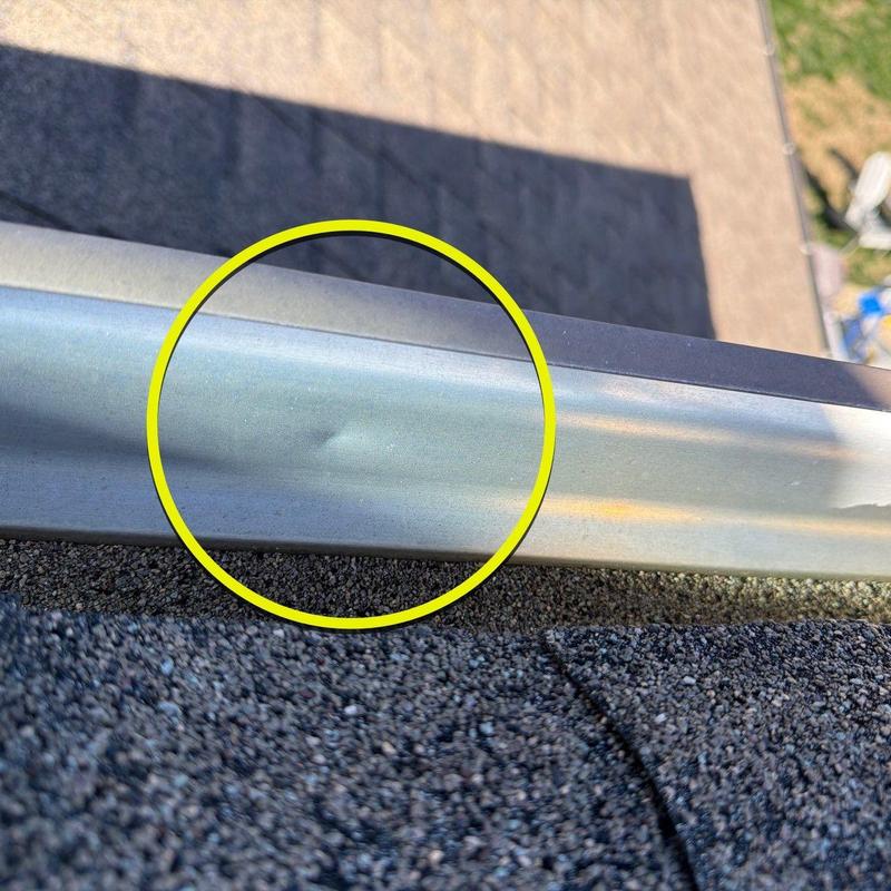 Metal roof drip edge with hail dent damage
