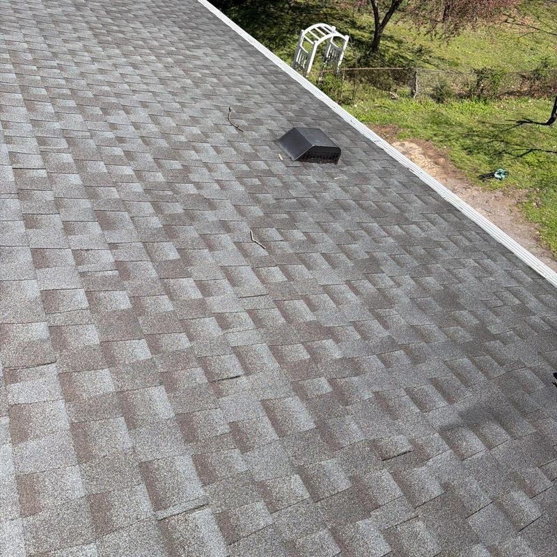 Roof shingles with visible hail damage and cracks