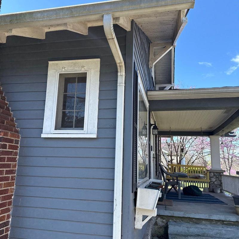 Gutter downspout with attached home porch and window