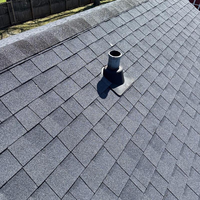Roof shingles and vent pipe flashing damaged by hail