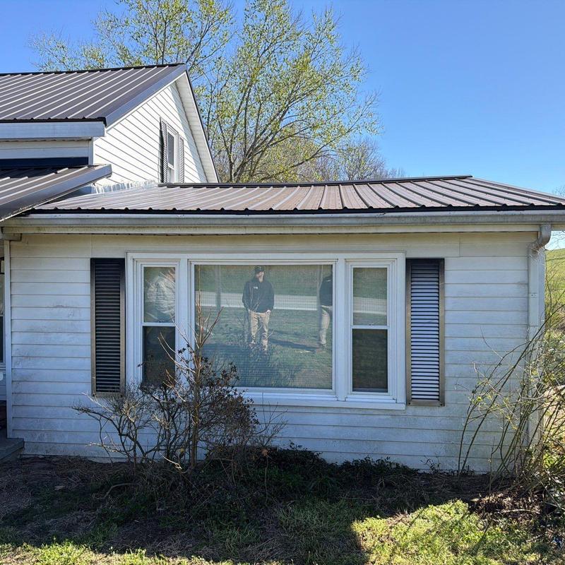 Metal roofing inspection with visible hail damage