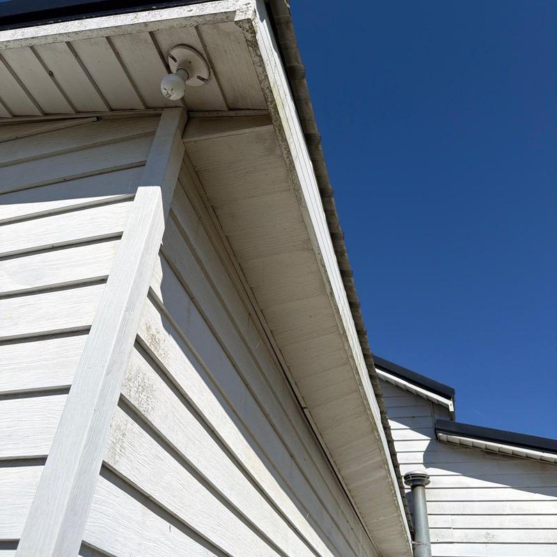 Roof edge and soffit inspection under clear sky