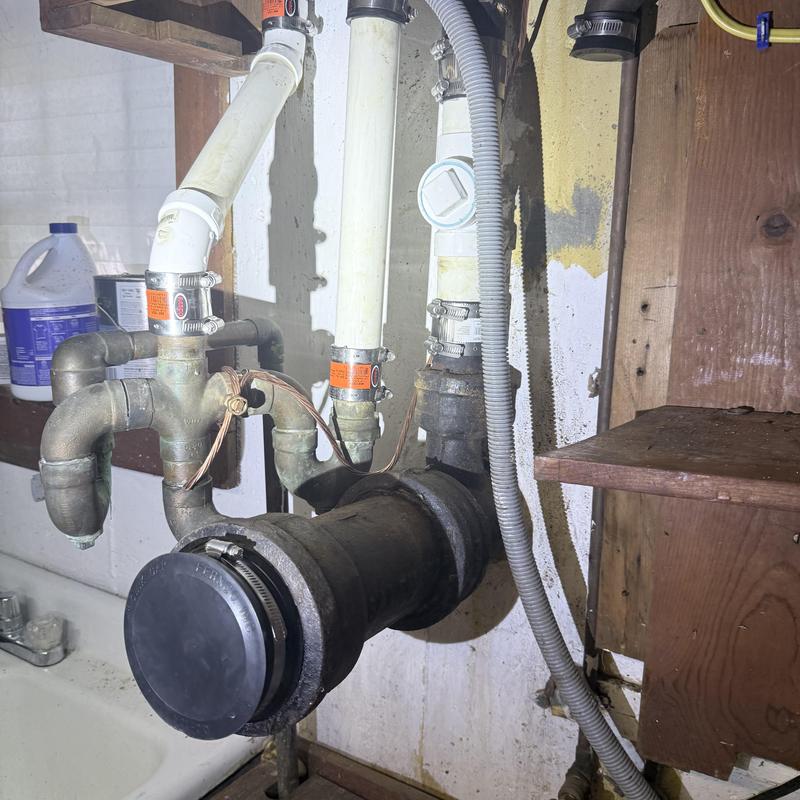 Kitchen drain pipes and fittings under sink with clamps Kitchen drain pipes and fittings under sink with clamps
