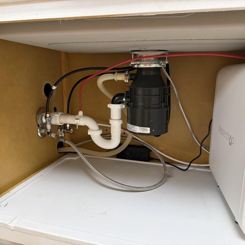 Garbage disposal with reworked drain and water lines