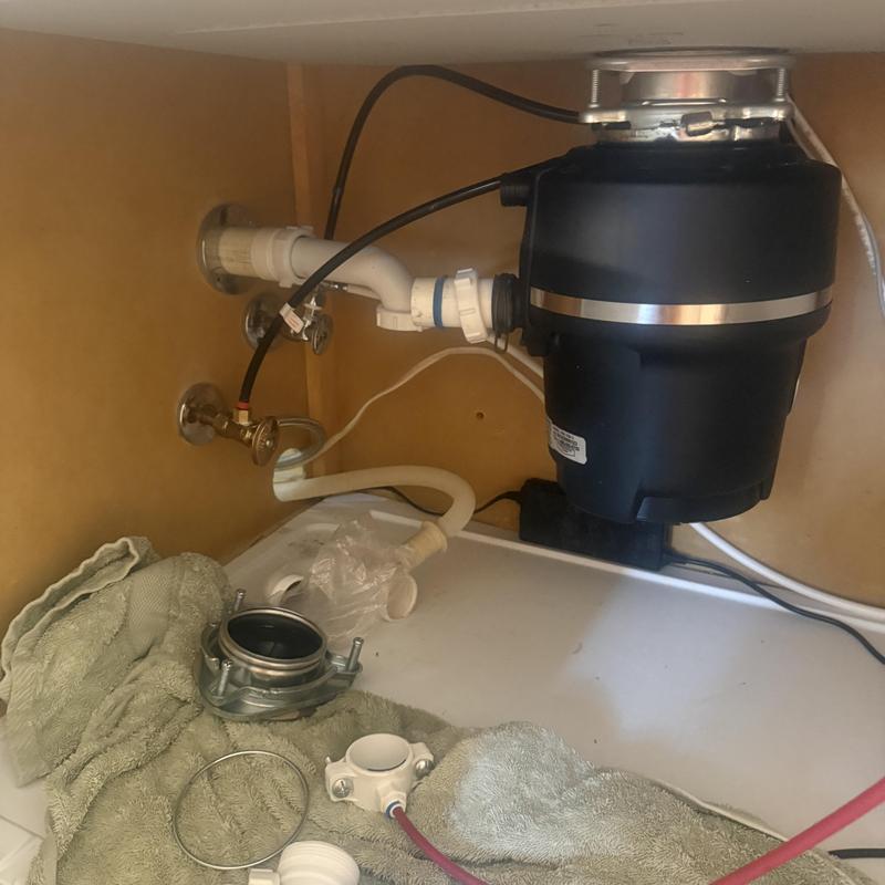 Garbage disposal under sink with plumbing parts