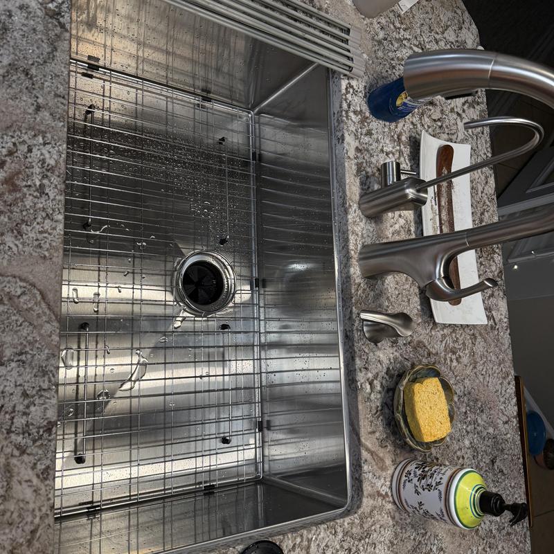Kitchen sink with stainless steel basin and faucet
