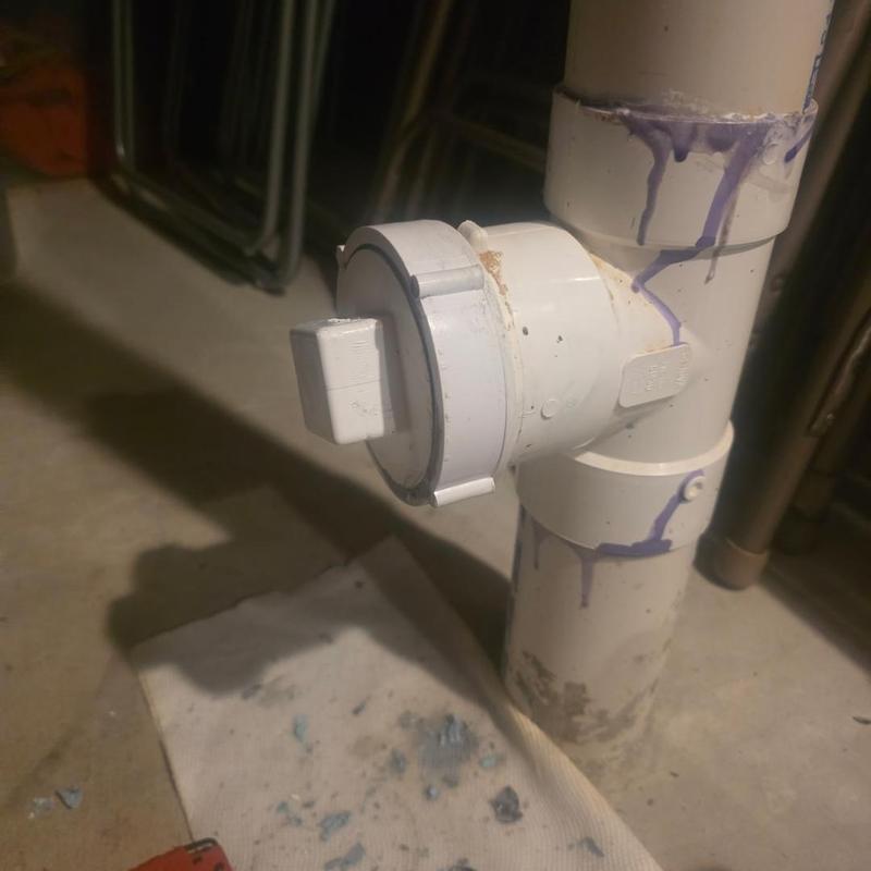PVC cleanout replacement with purple primer on pipe joints