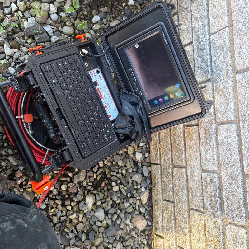 Toilet flange inspection camera setup on gravel ground