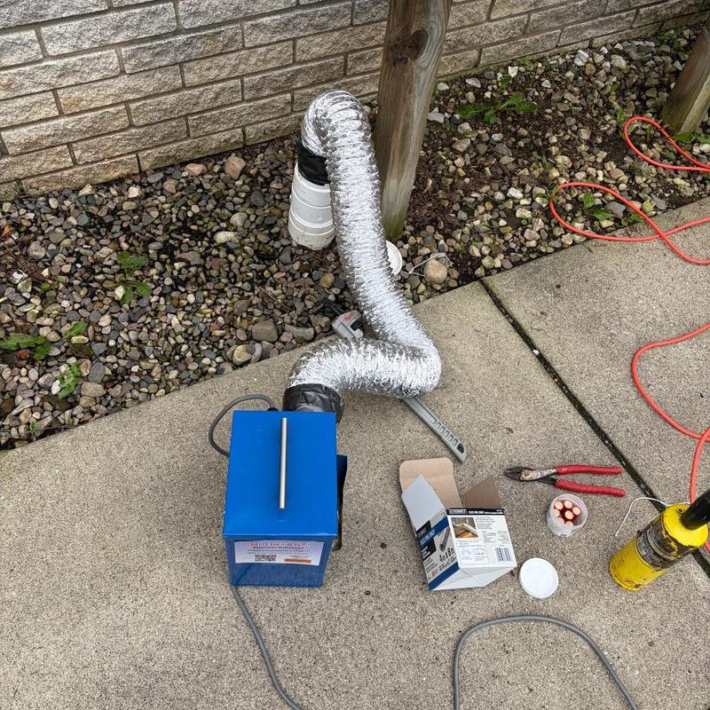 Toilet flange smoke testing with repair tools outdoors