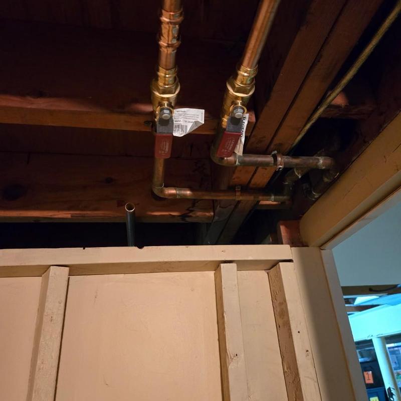 Gas line ball valves with copper piping above wall panel