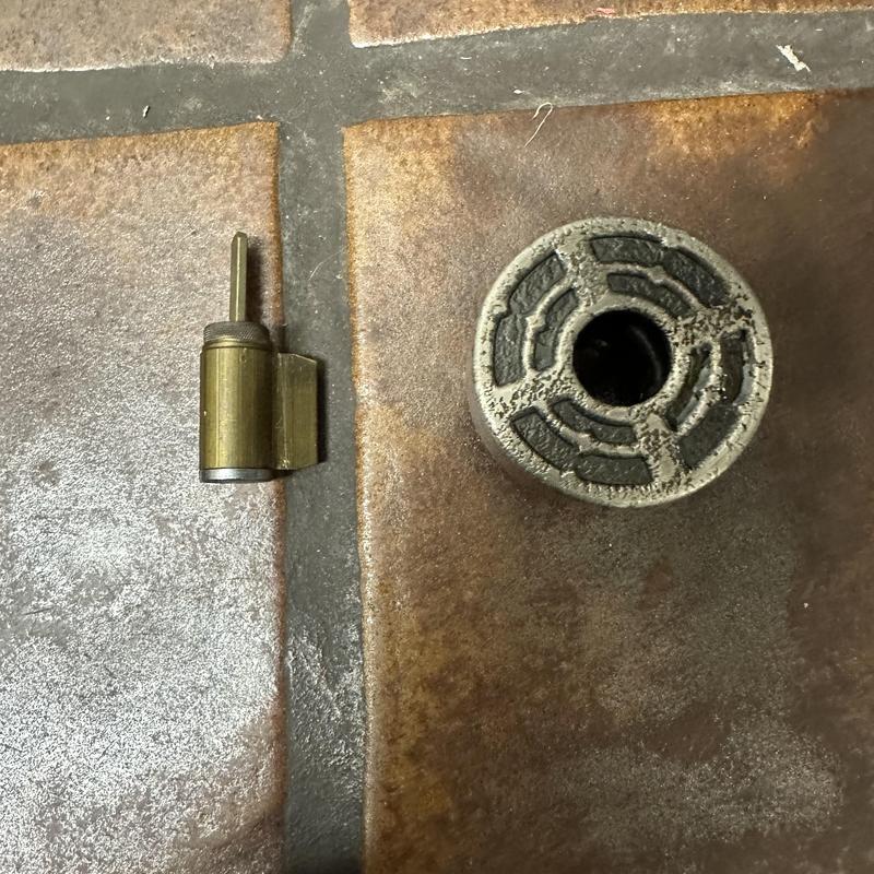 Office door lock cylinder and broken knob parts on tile floor Office door lock cylinder and broken knob parts on tile floor