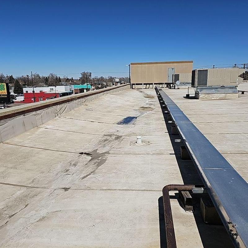 PVC flat roof with cracks and exposed plates