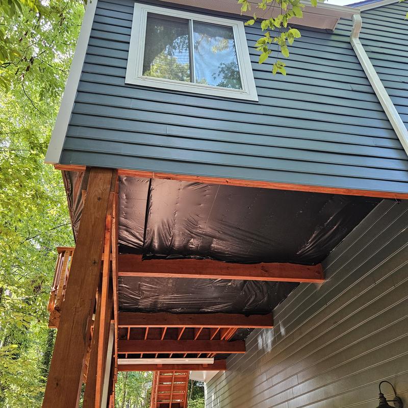 Elevated deck framing and black moisture barrier installation Elevated deck framing and black moisture barrier installation