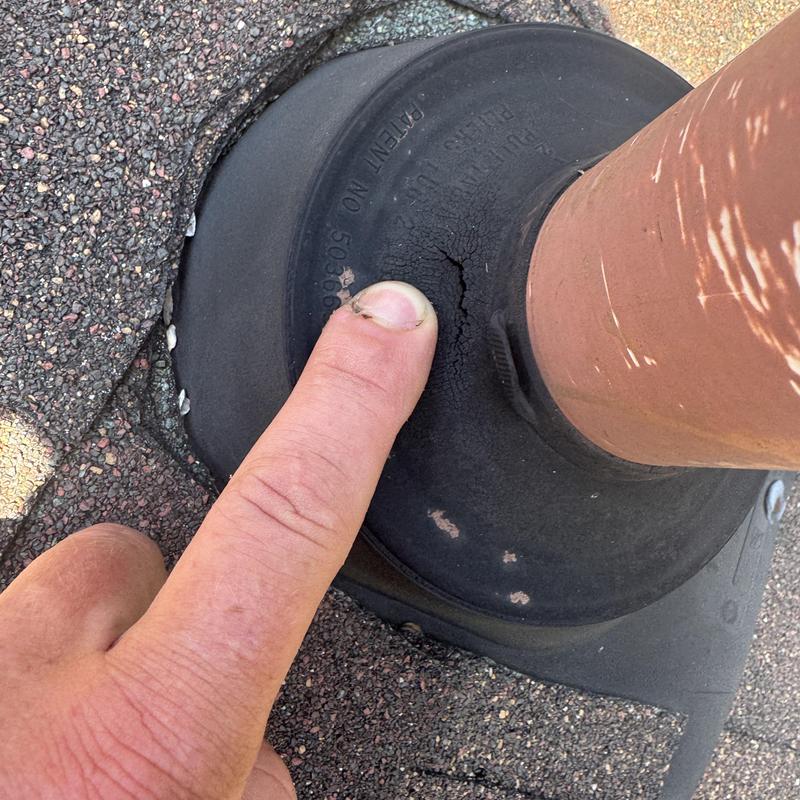Dry rotted pipe boot with crack on roof pipe seal Dry rotted pipe boot with crack on roof pipe seal