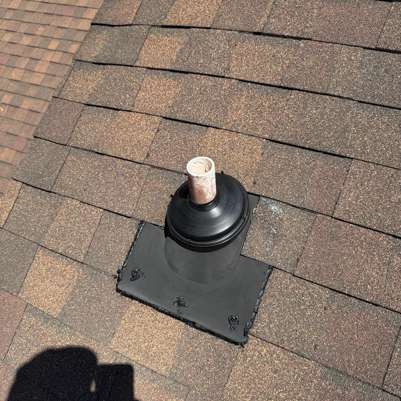 Pipe boot on shingle roof with patch sealant Pipe boot on shingle roof with patch sealant