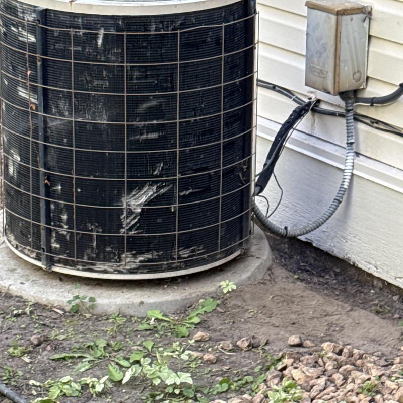 Air conditioner condenser unit with protective cage outdoors Air conditioner condenser unit with protective cage outdoors