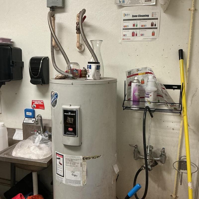 Water heater and mop sink in utility room Water heater and mop sink in utility room