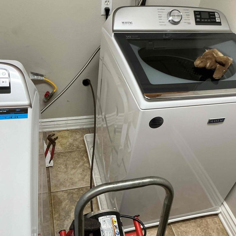 Laundry drain line snake service behind dryer