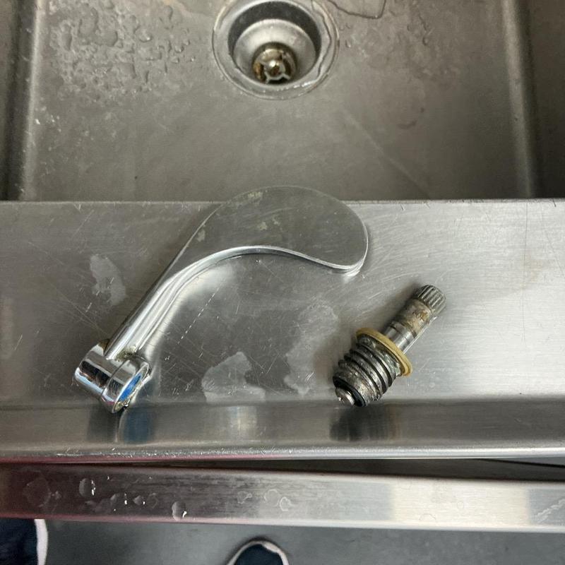 Faucet spindle and handle on stainless sink edge Faucet spindle and handle on stainless sink edge